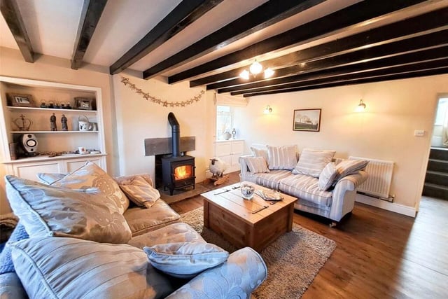 The spacious sitting room with wood-burning stove