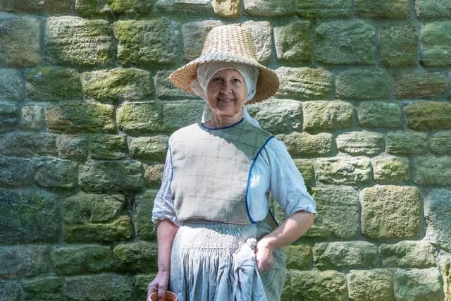Gill Johnson wears a 13th century peasant costume of a cyclas or unfitted tabard over a linen kirtle. “She is dressed for being out in the fields at harvest time and has a smocked apron to wipe her hands on,” says Tanya. Picture by Laura Mate.
