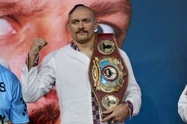 Ukraine's Oleksandr Usyk gestures as he holds a belt during a public weighing ahead of the heavyweight boxing rematch for the WBA, WBO, IBO and IBF titles between Usyk and Britain's Anthony Joshua, in the Saudi Red Sea city of Jeddah, on August 19, 2022. - The match, billed as Rage on the Red Sea, is set to take place on August 20, 2022, at the Jeddah Super Dome. (Photo by Giuseppe CACACE / AFP) (Photo by GIUSEPPE CACACE/AFP via Getty Images)