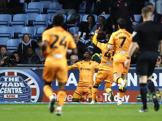 Hull City's Noah Ohio (centre) celebrates scoring their side's third goal of the game with team-mates during the Sky Bet Championship match at Coventry. Photo: Nigel French/PA Wire.