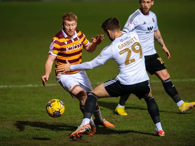 ON TARGET: Brad Halliday - pictured battling with Salford City's Luke Garbutt - scored the Bantams equaliser on Tuesday night. Picture: Bruce Rollinson