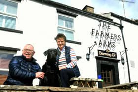 Andy Gascoigne and wife Mandy with their dog Buddy outside The Farmers Arms at Muker