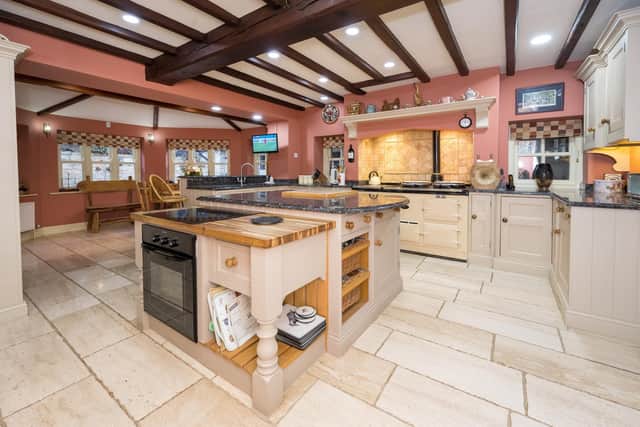 The kitchen with handcrafted cabinets and a Aga