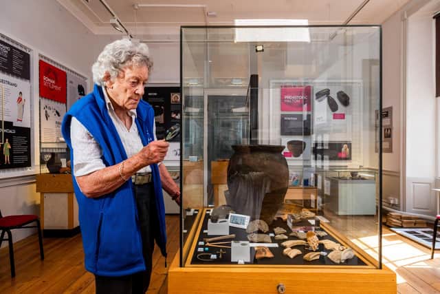 Mary Rohan, one of the volunteers at the museum looking at the artefacts on display found during an excavations at Brooklyn House, Norton.
