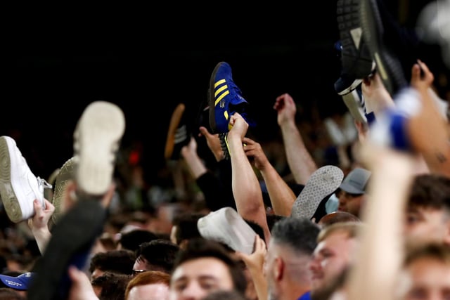 Leeds United fans show their support by taking their shoes off during the Carabao Cup Second Round match between Leeds United and Barnsley at Elland Road on August 24.