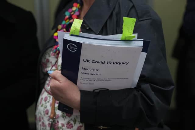 A person holds a copy of the UK Covid-19 inquiry - module 6. PIC: Jeff Moore/Press Association