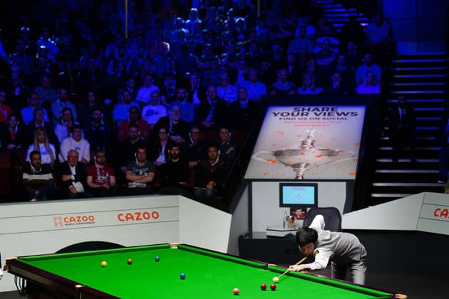 Si Jiahui in action against Luca Brecel (not pictured) on day fourteen of the Cazoo World Snooker Championship at the Crucible Theatre, Sheffield. Photo credit : Zac Goodwin/PA Wire.