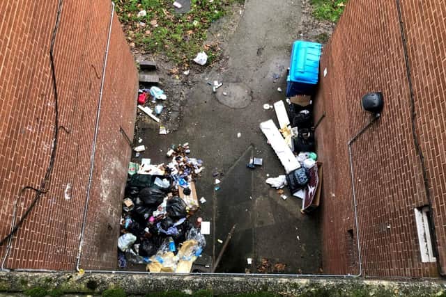 Rubbish piled up on a housing estate where a city council has locked away wheelie bins and told residents to use bin chutes - which are too small