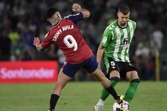 Leeds United target: Osasuna's Argentinian forward Ezequiel "Chimy" Avila (L) challenges Real Betis' Argentinian midfielder Guido Rodriguez (Picture: CRISTINA QUICLER/AFP via Getty Images)
