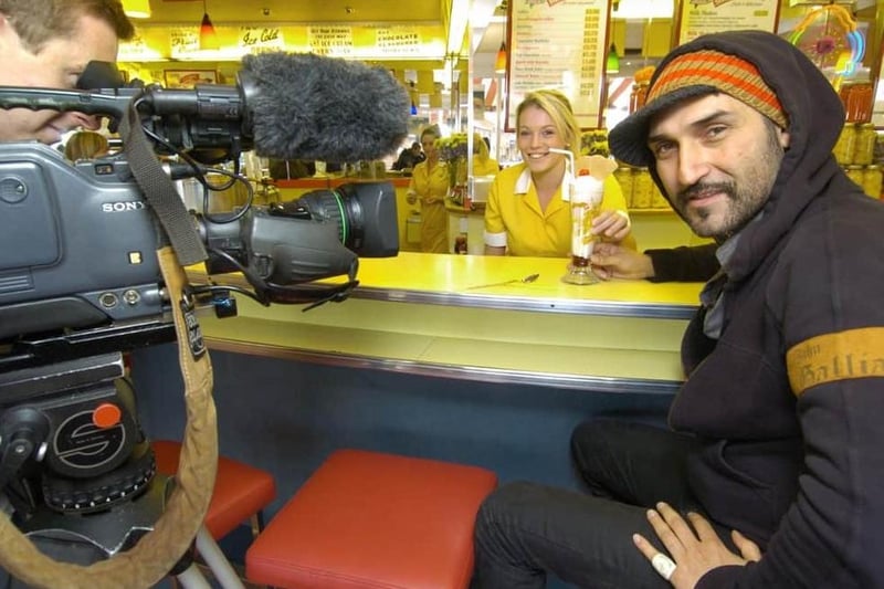 Iranian TV presenter Behzad Bolour enjoys an ice cream in the Harbour Bar with cameraman Rory Marshall and staff member Charlotte Davis, in 2008.