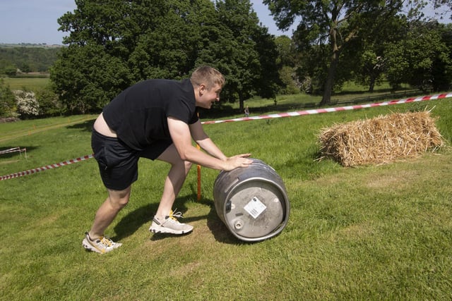 Competitorspushing an 18-gallon beer barrel uphill on a stamina-sapping course. Picture taken by Yorkshire Post Photographer Simon Hulme 29th May 2023
