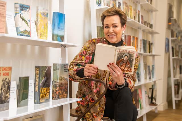 Christa Ackroyd, journalist and former broadcaster and committee member of the Bronte Birthplace in Thornton, Bradford, holding a copy of Jane Eyre by Charlotte Brontë whilst visiting John Atkinson Fine & Rare Books on Royal Parade, Harrogate.Picture By Yorkshire Post Photographer,  James Hardisty.