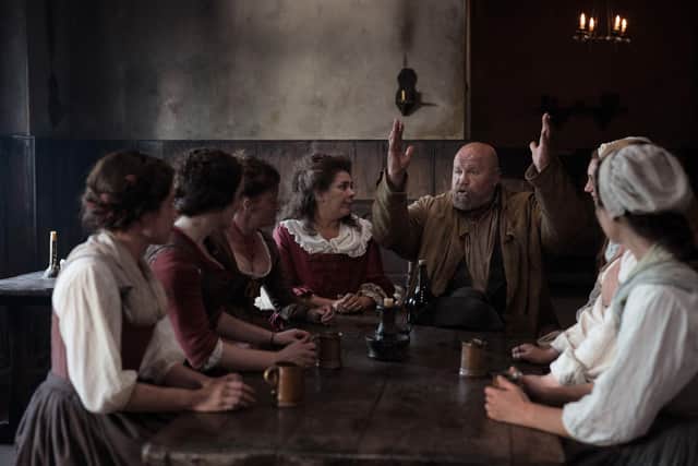 A scene from The Gallows Pole, now on BBC iPlayer, showing villagers discussing the get rich quick plot
