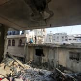 People search through buildings that were destroyed during Israeli air raids in the southern Gaza Strip in November. PIC: Ahmad Hasaballah/Getty Images
