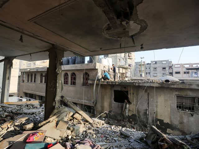 People search through buildings that were destroyed during Israeli air raids in the southern Gaza Strip in November. PIC: Ahmad Hasaballah/Getty Images