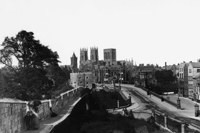 The mediaeval city walls around the old part of York with York Minster in the background, circa 1890.