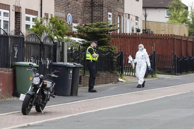 Forensic officers arrive at a scene where two people were murdered on May 15, in Huddersfield