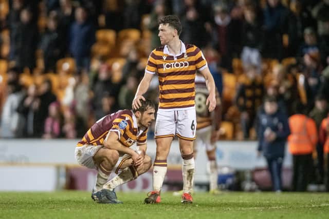 DISAPPOINTMENT: Bradford City captain Richie Smallwood consoles Sam Stubbs at the final whistle as the Bantams miss the chance to go to a Wembley Football League Trophy final thanks to a late Wycombe Wanderers goal