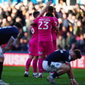 HOPE: Huddersfield Town's players celebrate as Millwall's players sink to their knees at the final whistle at The Den Picture: Victoria Jones/PA
