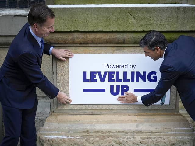 Chancellor Jeremy Hunt (left) and Prime Minister Rishi Sunak during a community project visit to Accrington Market Hall in Lancashire. Mr Sunak has reiterated his commitment to levelling up as the Government announced £2 billion for more than 100 projects across the UK. Picture date: Thursday January 19, 2023.
