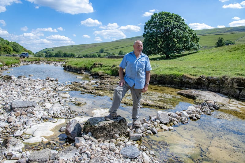 Local farmer Stewart Lund by the River Skirfare in Littondale where it disappears underground during the summer months photographed for the Yorkshire Post by Tony Johnson.