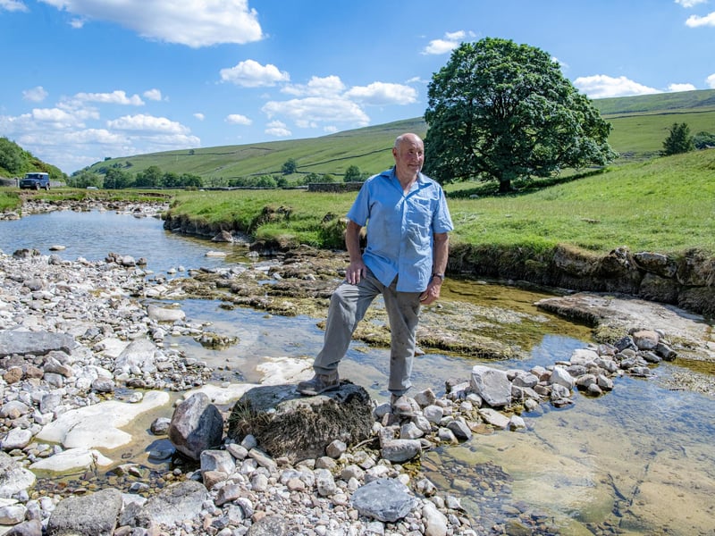 Local farmer Stewart Lund by the River Skirfare in Littondale where it disappears underground during the summer months photographed for the Yorkshire Post by Tony Johnson.