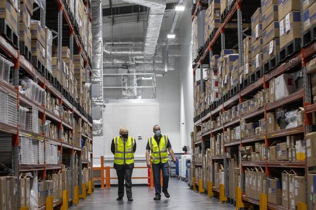Library image of the former Prime Minister Boris Johnson (left) walking with warehouse supervisor Laurence Wilkinson, during a tour of the manufacturing facility for the Oxford/Astrazeneca vaccine at Oxford Biomedica in Oxfordshire. Picture date: Monday January 18, 2021.