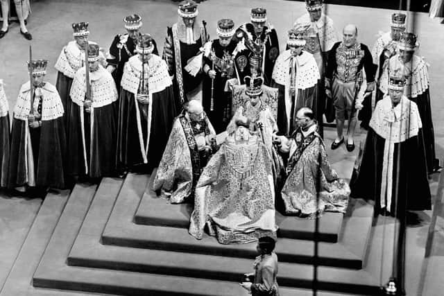 File photo dated 02/06/1953 of Queen Elizabeth II on the throne as bishops pay homage to her during her Coronation in Westminster Abbey, London. The Queen died peacefully at Balmoral this afternoon, Buckingham Palace has announced. Credit: PA Wire