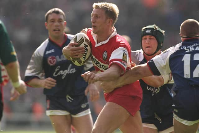 Denis Betts of Wigan Warriors charges forward as Mark Aston, left, looks on (Picture: Alex Livesey/Allsport)