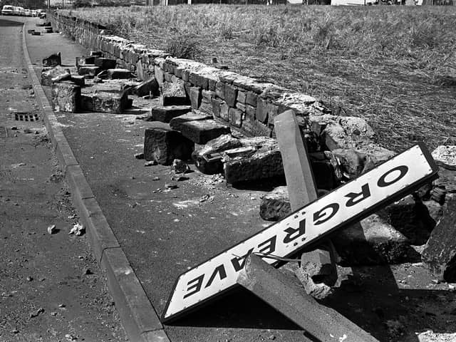A twisted sign, felled concrete posts and a broken wall following violence outside a coking plant in Orgreave, South Yorkshire, in 1984. PIC: PA/PA Wire