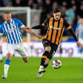 Alfie Jones holds off Jordan Rhodes in Hull City's match with Huddersfield Town in January. Picture: Bruce Rollinson.
