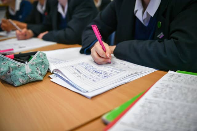 Pupils taking examinations. Stock photo.