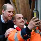 Prince William poses for pictures with Leigh Stinchcombe on his way to attend a Homewards Sheffield Local Coalition meeting, at the Millennium Gallery, in Sheffield, about how to tackle homelessness. The Prince of Wales even offered to hold Leigh's drinks cup so he could fish out his phone.