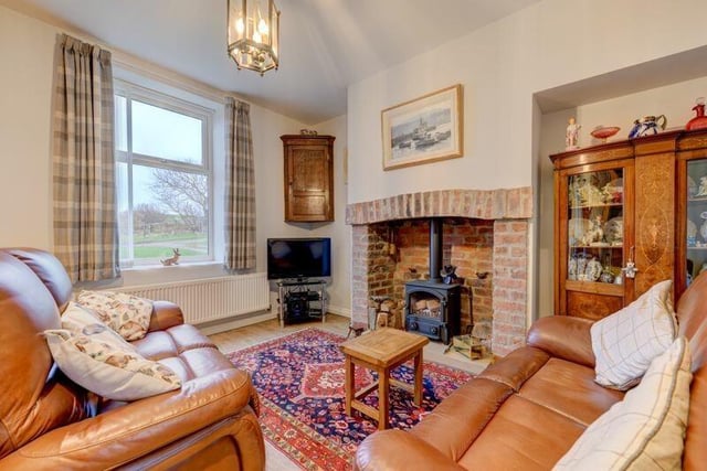 The cosy sitting room with a wood-burning stove