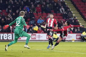 Sheffield United's Cameron Archer (right) attempts a shot on goal during the Premier League match at Bramall Lane, Sheffield. Picture date: Wednesday December 6, 2023. PA Photo. See PA story SOCCER Sheff Utd. Photo credit should read: Danny Lawson/PA Wire.

RESTRICTIONS: EDITORIAL USE ONLY No use with unauthorised audio, video, data, fixture lists, club/league logos or "live" services. Online in-match use limited to 120 images, no video emulation. No use in betting, games or single club/league/player publications.