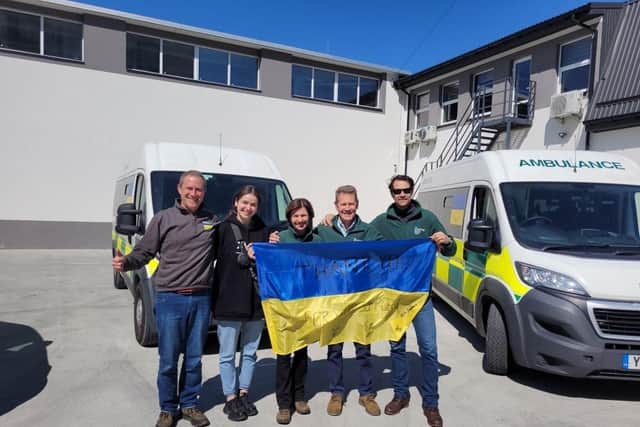 Country Food Trust CEO SJ Hunt (centre), Simon Brake (far left) from Mighty Convoy and the team handing over the ambulances and food in Lviv.