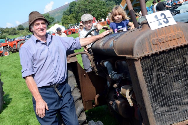 Allan Steeples, of Sparrow Pit, Buxton, with his tractor at Hope Show 2013 pictured with grandson Jack Cooper, aged nine, and Lydia Gilman, aged four.