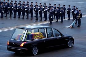 The Queen's coffin is taken away in the Royal Hearse from the Royal Air Force Northolt airbase on September 13 to Buckingham Palace. (Pic credit: Andrew Matthews / AFP via Getty Images)