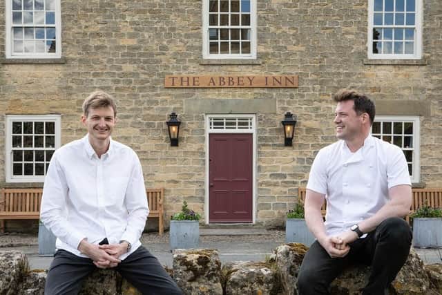 Charlie Smith and Tommy Banks in front of the new pub. (Pic credit: The Abbey Inn)