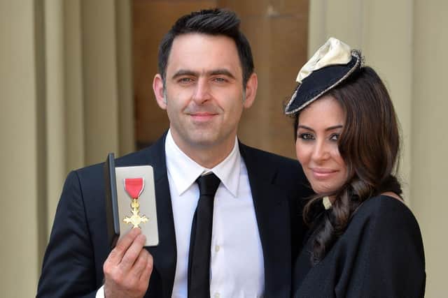 Ronnie O'Sullivan receiving an OBE in 2016 with his partner, actress Laila Rouass. Credit: John Stillwell/PA Photo.