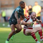 Wigan Warriors' Liam Marshall in action with Huddersfield Giants' Kevin Naiqama (Picture: John Clifton/SWpix.com)