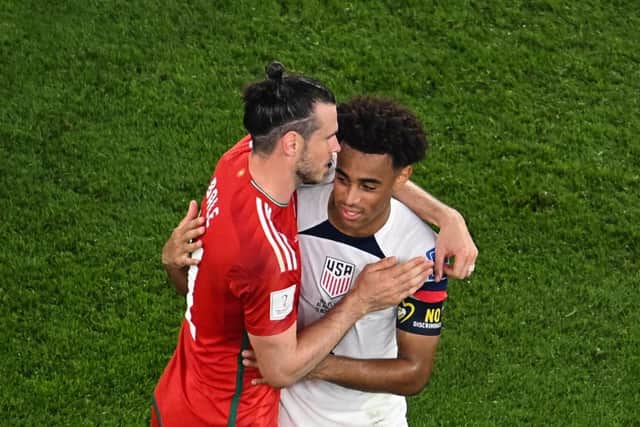 Wales' forward #11 Gareth Bale (L) and USA's midfielder #04 Tyler Adams greet each other after tying 1-1 in the Qatar 2022 World Cup Group B football match between USA and Wales at the Ahmad Bin Ali Stadium in Al-Rayyan, west of Doha on November 21, 2022. (Photo by ANTONIN THUILLIER/AFP via Getty Images)