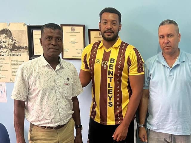 INTERNATIONAL DREAM - Dinnington Town's Jay Atkin flanked by head of the Seychelles FA Georges Bibi (left) and Seychelles coach Michael Delpeche (right)