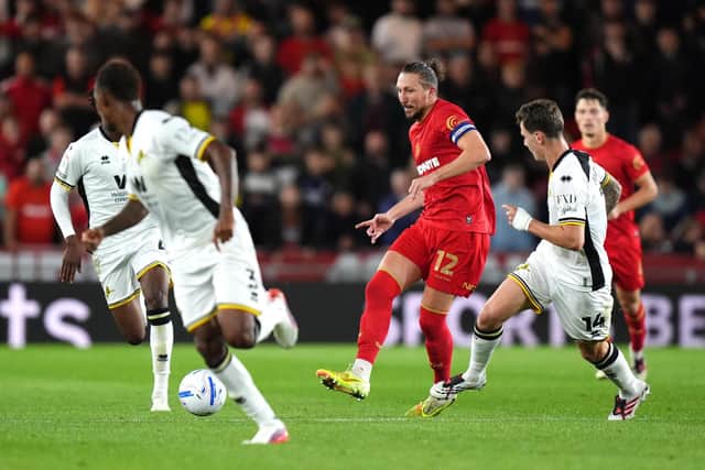 Middlesbrough's Luke Ayling (centre) and Millwall's Jenson Metcalfe (right) battle for the ball during the Sky Bet Championship match at Riverside Stadium, Middlesbrough.