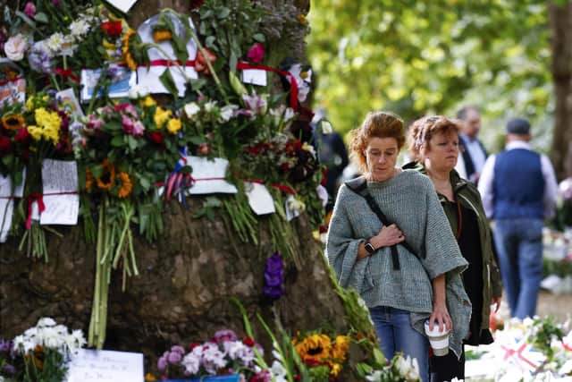 People view flowers at a memorial site in Green Park near Buckingham Palace  (Photo by Jeff J Mitchell/Getty Images)