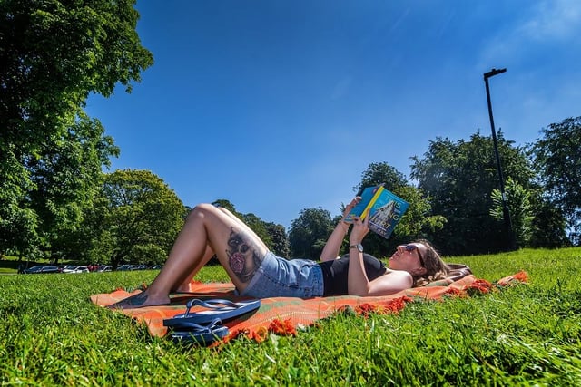A woman from Australia who works in Harrogate sunbathes on The Stray in Harrogate.