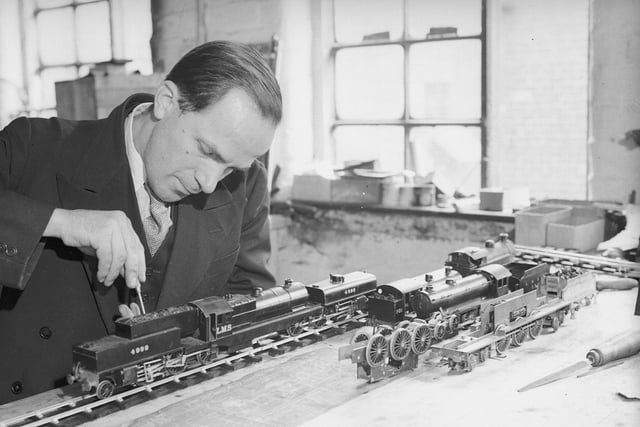 Miniature railway craftsman, Frank Mills, works on a scale model of an LMS Garratt locomotive in his Sheffield workshop in July 1935.