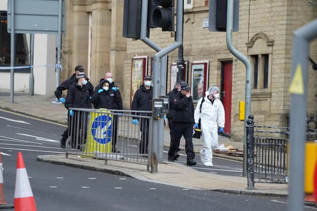 Police and forensic officers on Fountain Street near the scene of a triple stabbing in Commercial Street in Halifax, West Yorkshire. Photo credit: Danny Lawson/PA Wire
