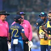 Flashpoint in Delhi as the umpires explain the situation to Angelo Mathews and the Sri Lankans. Photo by Arun Sankar/AFP via Getty Images.