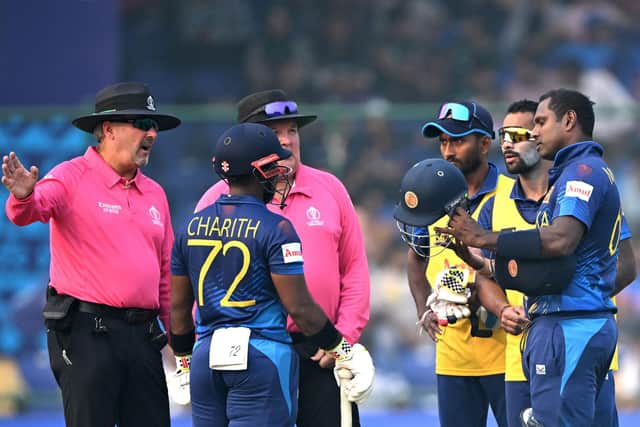 Flashpoint in Delhi as the umpires explain the situation to Angelo Mathews and the Sri Lankans. Photo by Arun Sankar/AFP via Getty Images.